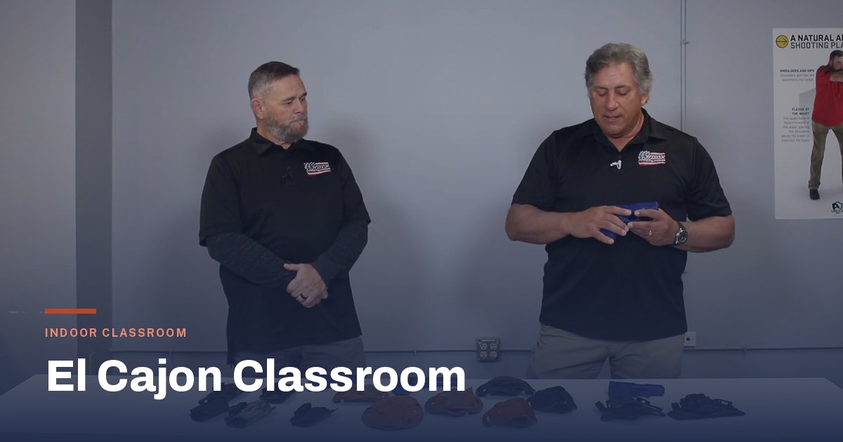 Bill Desy and Joe Drammissi demonstrating carry equipment in an indoor classroom session